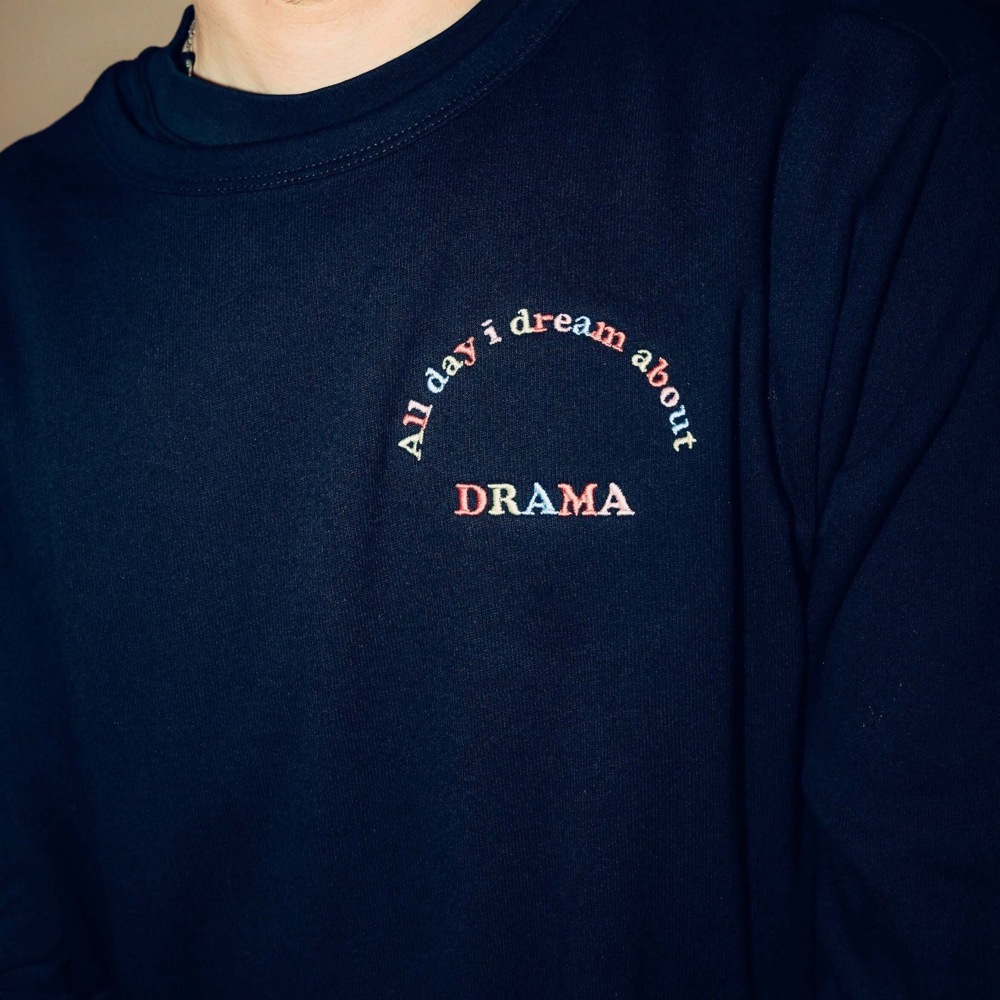 Close up view of DRAMA All Day I Dream About DRAMA Crewneck embroidery