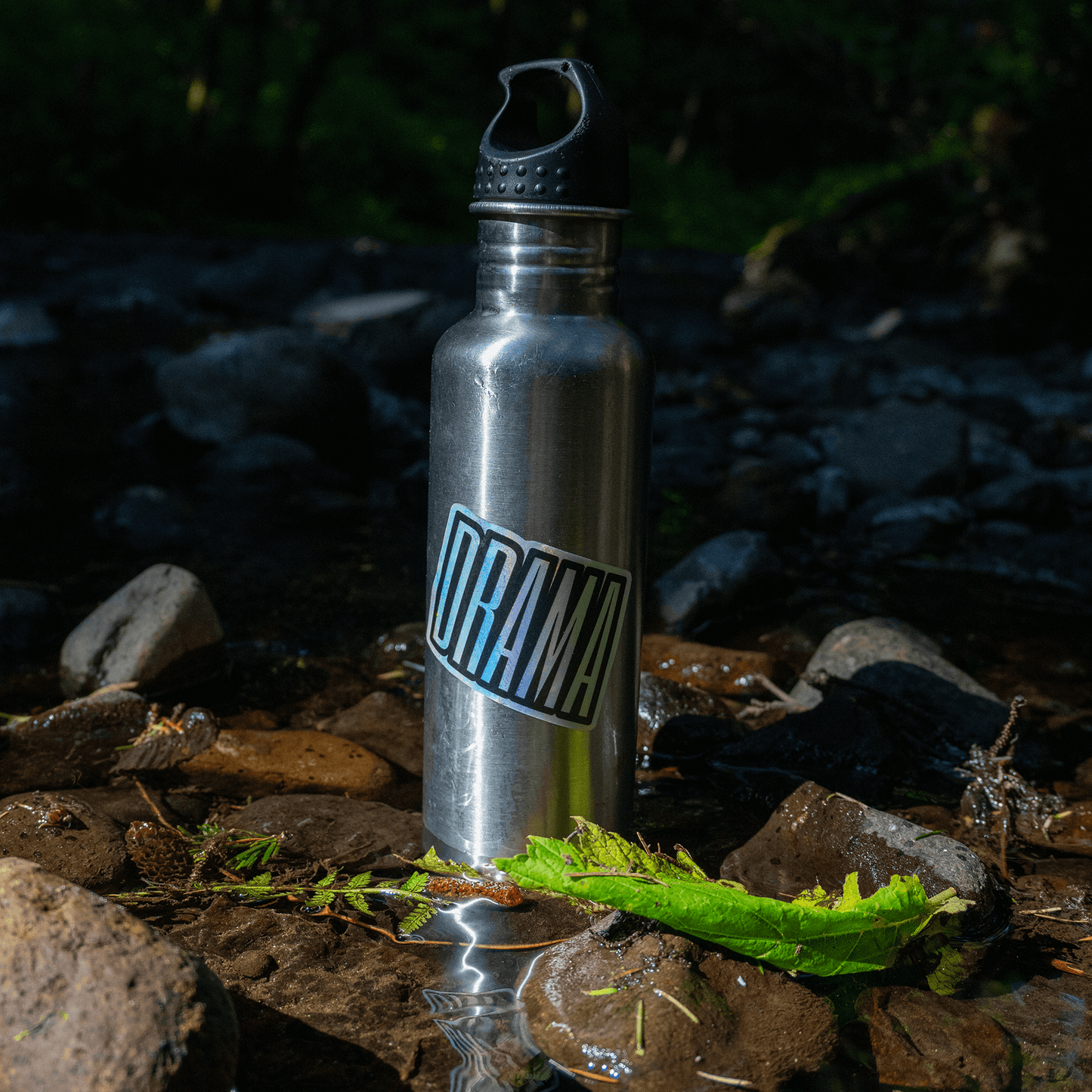 DRAMA Holographic Logo Sticker on a water bottle