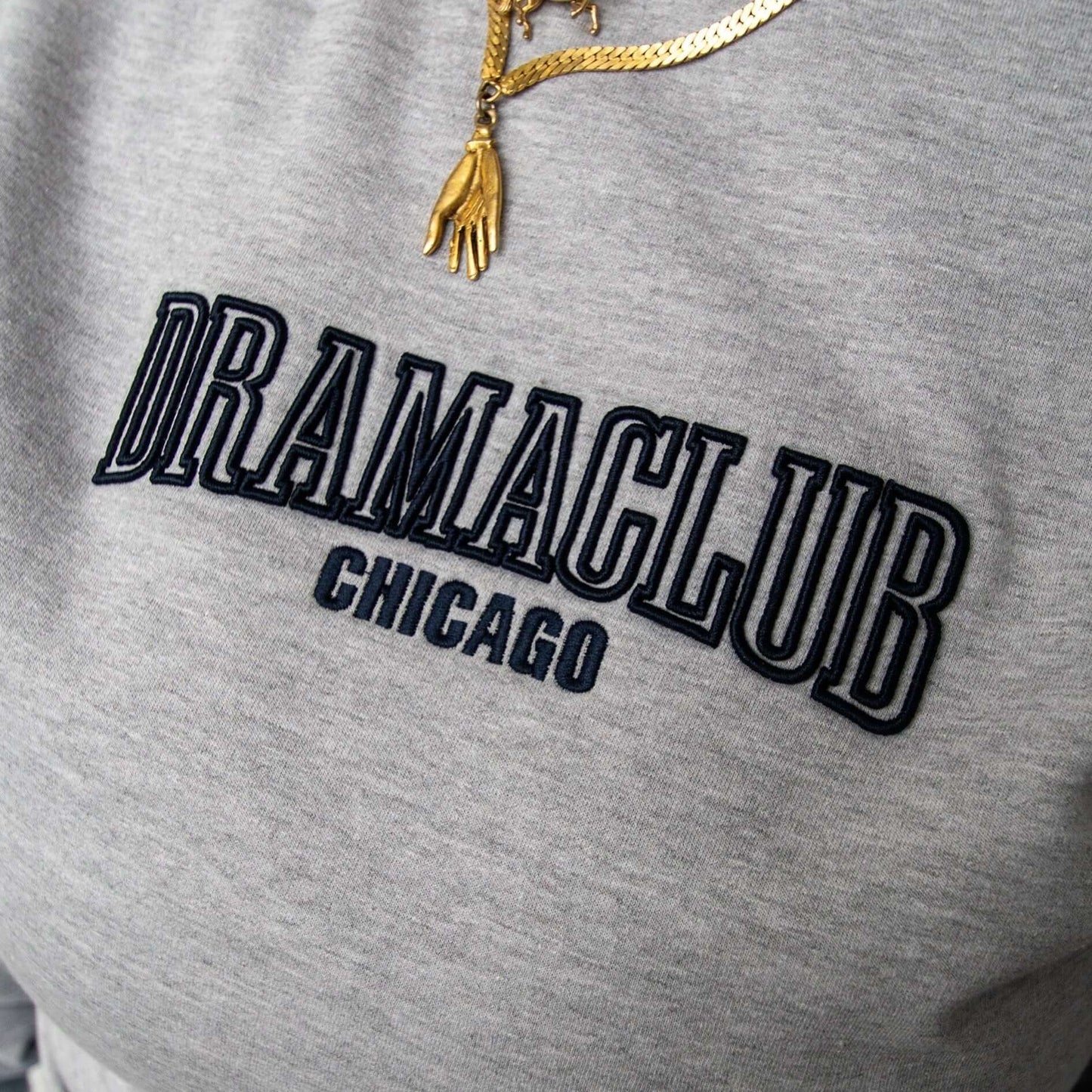 DRAMA Club Crewneck in gray close up of embroidery
