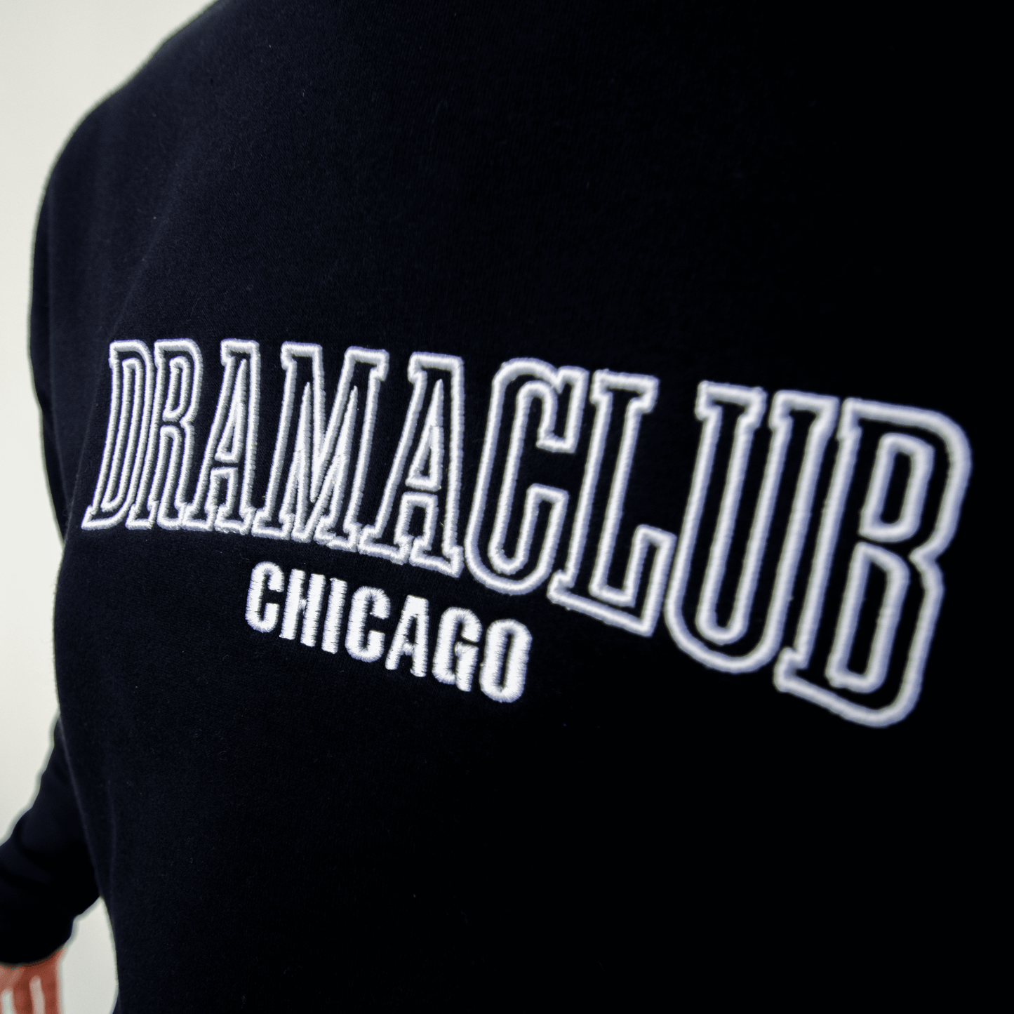 DRAMA Club Crewneck in navy close up of embroidery