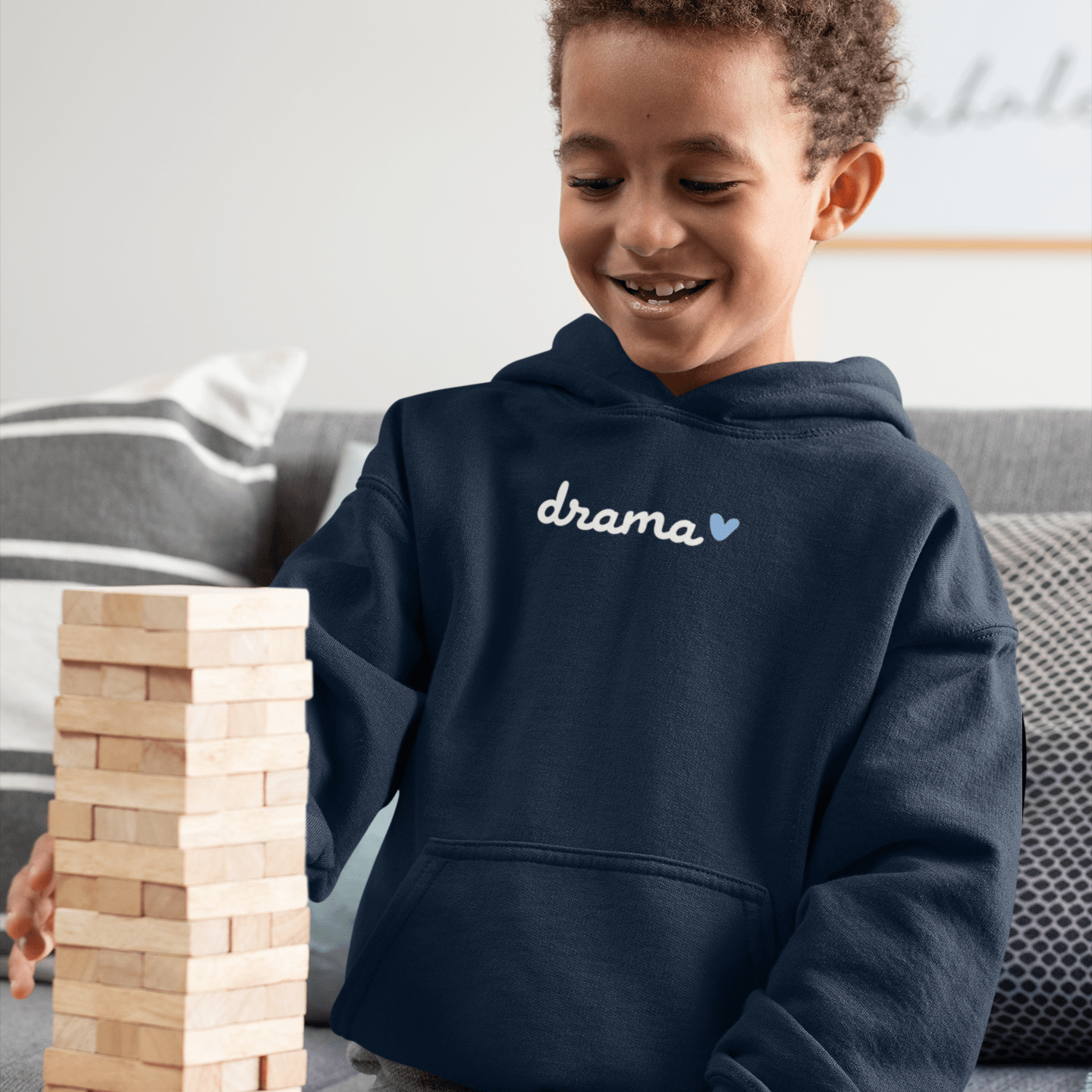 Toddler smiling wearing DRAMA Toddler Hoodie in navy