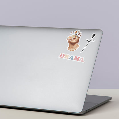 DRAMA All Day I Dream About Drama Sticker on the front of a laptop with two other sticker designs