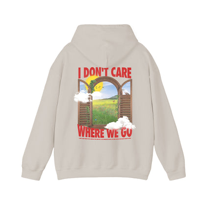 back of beige hoodie with I don't care where we go text and window sunset graphic printed on the full back