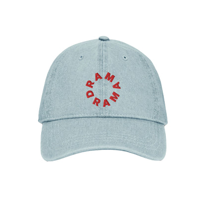 Front view of light blue DRAMA Denim Cap with red DRAMA lettering embroidered in a circle and a curved brim.