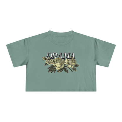 Front view of green DRAMA Roses Crop Top with black DRAMA lettering above yellow roses and dark leaves.