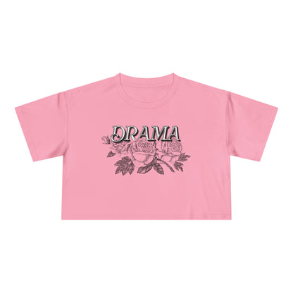 Front view of pink DRAMA Roses Crop Top with black DRAMA lettering above pink roses and dark leaves.