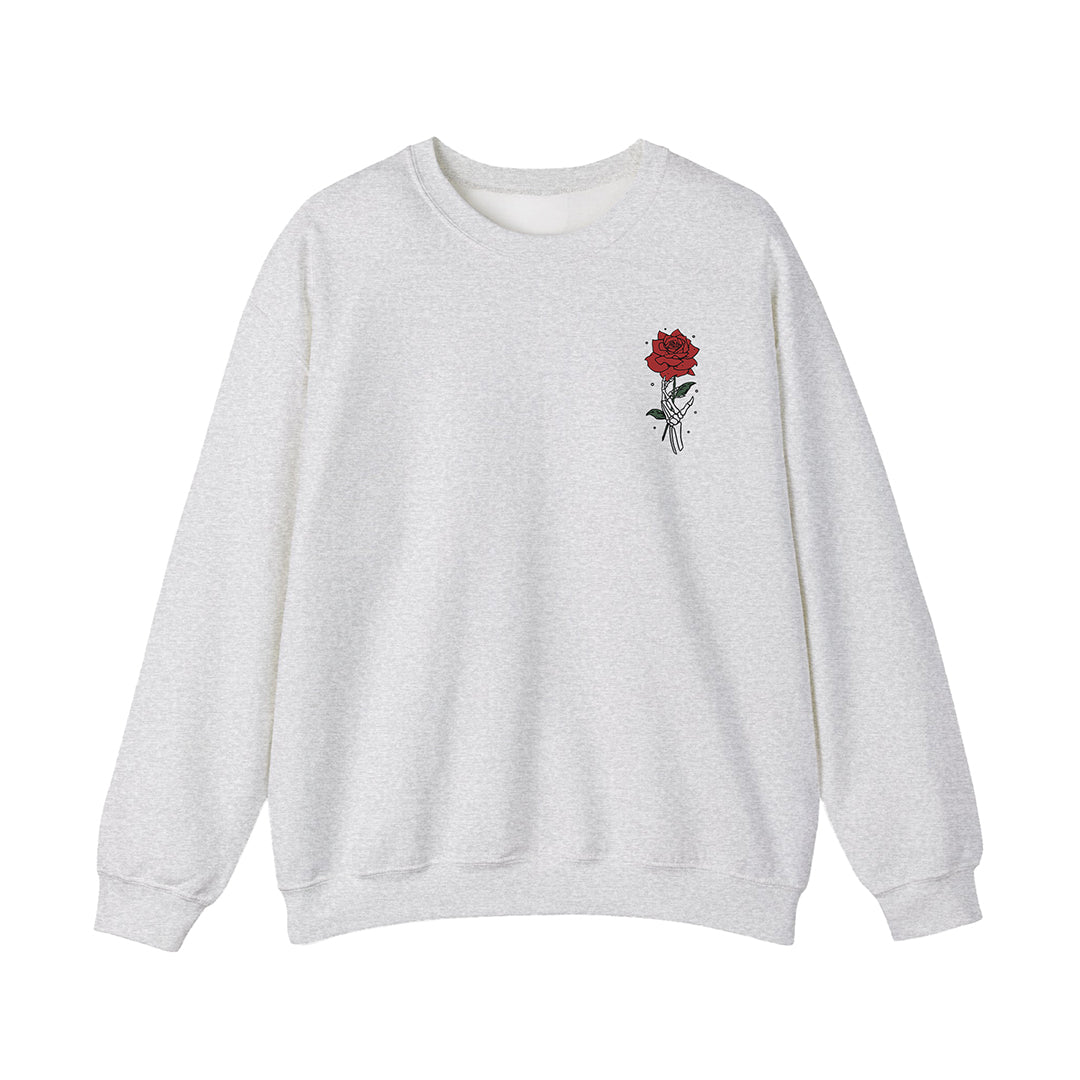Light gray DRAMA Lovers Crewneck with a small red rose and hand illustration on the left chest.