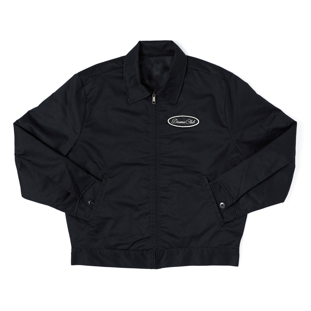 A black zip-up jacket with a stand collar, featuring a small white oval 'Dreamers Club' logo on the left chest, laid flat against a white background.