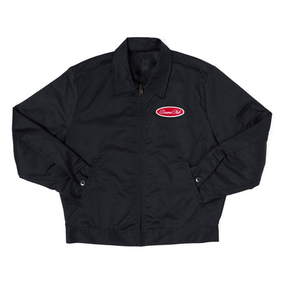 A black zip-up jacket with a pointed collar, long sleeves, and a red oval 'DRAMA Club' logo patch on the left chest, displayed flat against a white background.